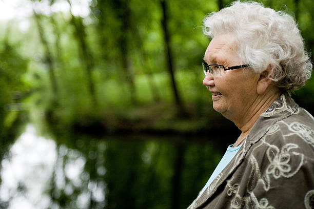 istock Grandmother standing near a stream 97627450