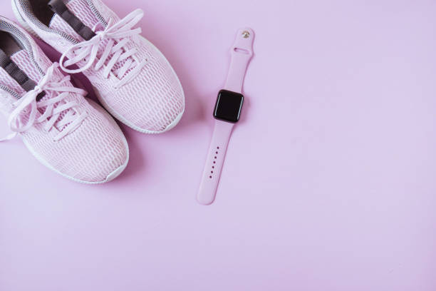 istock Violet sneakers and watcheson pink background. 976276312