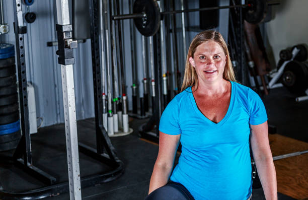 istock Pregnant Woman Resting Between Cross Training Gym Exercises 976276576