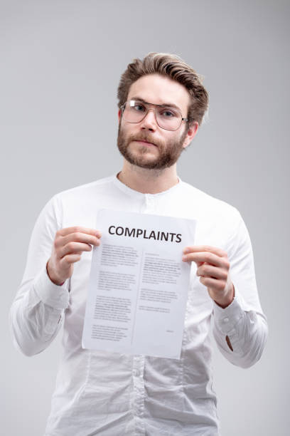 istock Angry resolute man holding a list of Complaints 976280214