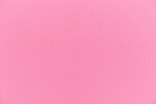 istock Backdrop texture of pink paper cardboard with vertical corrugated lines. 976293792