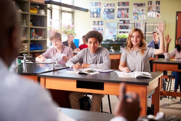 istock Male High School Tutor Teaching Students In Biology Class 976325952