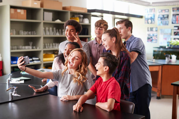 istock Group Of High School Students Taking Selfie In Biology Classroom 976330344