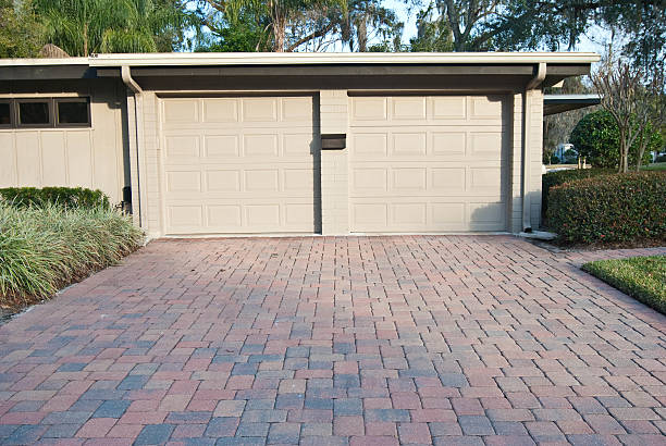 istock Beige Two Car Garage with Brick Driveway attached to Home 97635023