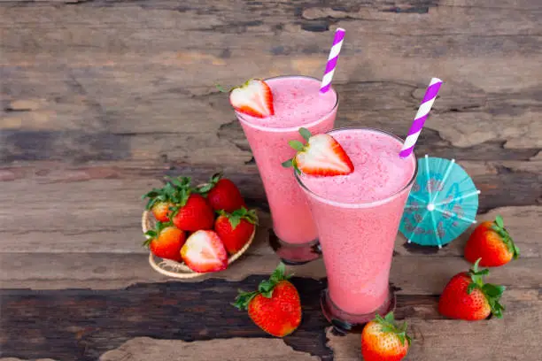 Strawberry smoothies juice beverage healthy fruit the taste yummy In glass drink episode morning on wood background