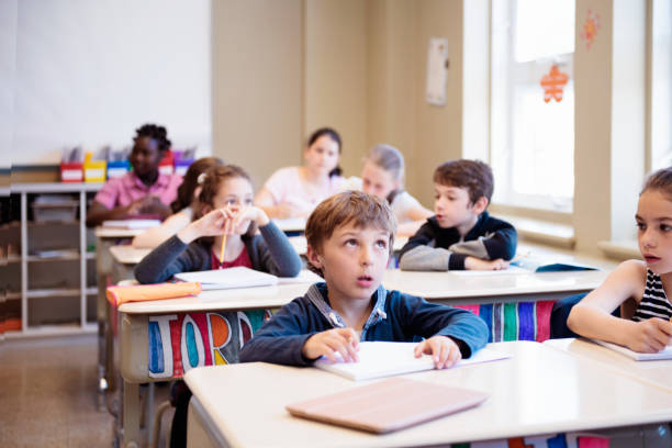 istock Multi-ethnic students sit into the class for the first day at school 976362434