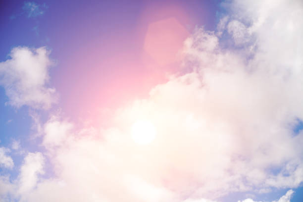 istock clouds against a blue sky with rays of the sun 976362542