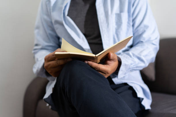 istock man reading a book and holding cup of coffee Sit Read Knowledge 976370162