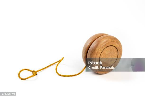 Close Up Of A Wooden Yoyo With Yellow String On White Background Stock Photo - Download Image Now