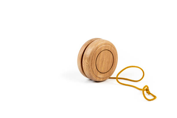 istock Close up of a wooden yo-yo with yellow string on white background. 976395520