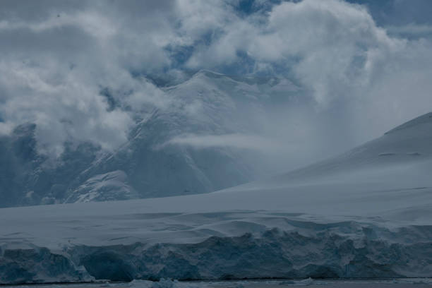 istock antartica mountains and wild penguins 976423450
