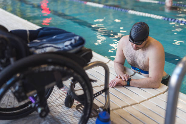 istock Adaptive athlete prepares to swim in a pool 976426268