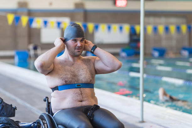 istock Adaptive athlete prepares to swim in a pool 976426334