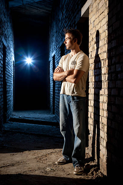 Man standing against doorway  crud stock pictures, royalty-free photos & images