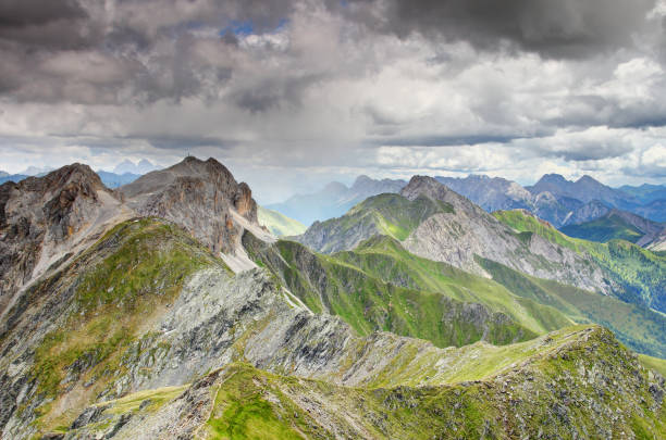 istock Rain shaft hits zigzagging Carnic Alps main ridge Italy Austria 976438094
