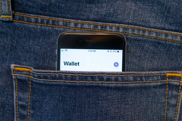 Mobile Pay Beijing, China - June 6, 2018: Mobile phone in a denim jeans back pocket. The phone shows a Wallet App display. apple computer stock pictures, royalty-free photos & images