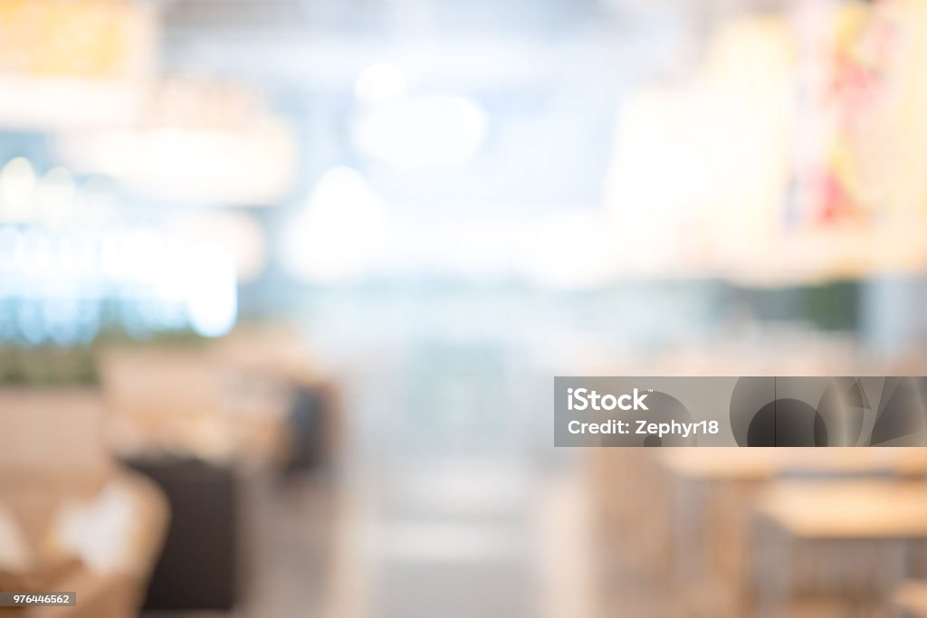 Abstract blurred restaurant background. Blurry cafe or coffee shop with dining tables, chairs and other decorations. Blur backdrop for design element. Food and beverage concept. Restaurant Stock Photo