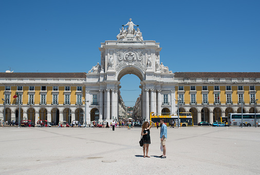 Lisbon - June 19, 2016. Crowds of tourists enjoying the warm sunshine in the Praca do Comercio, the landmark square overlooked by the historic Rua Augusta Arch in the heart of Lisbon, Portugal’s vibrant capital city.