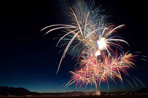 Many colorful fireworks bursts for a July 4th celebration in Eastern California.