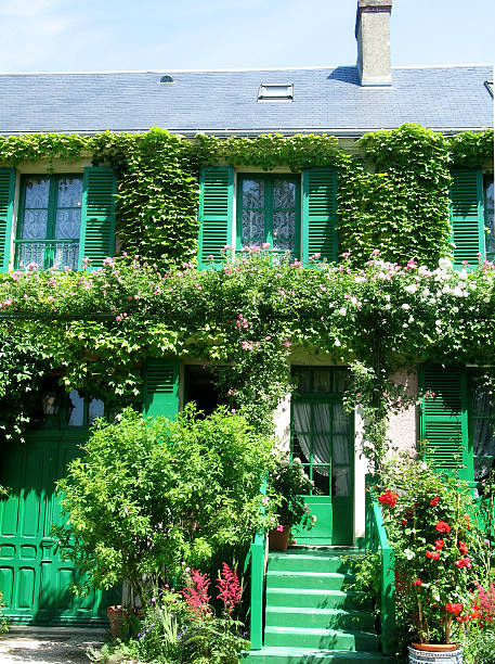 Monet's flowered home flowers covering Monet's home in Giverney, France. foundation claude monet photos stock pictures, royalty-free photos & images