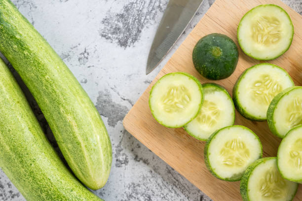 istock Fresh cucumber slices on a cutting board. Top view 976469856