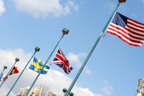 A Bermudan flag waving on a pole in a blue sky