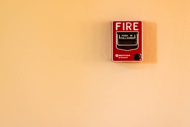 istock Fire break glass alarm switch on the cement wall. 976489930