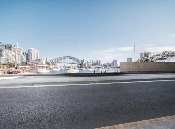 istock empty waterfront road with Sydney Harbor Bridge on background 976510098