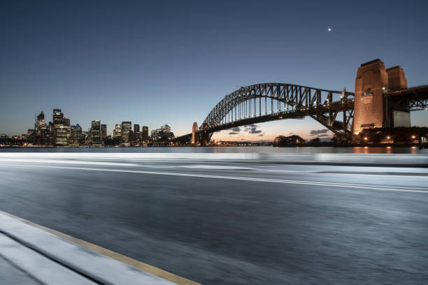 istock blurred motion road by Sydney Harbor Bridge on background 976510382