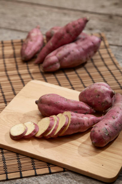 istock Raw sweet potato on wooden table 976512804