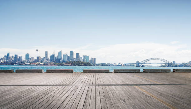 istock empty wooden plank with sydney harbor bridge on background 976513214