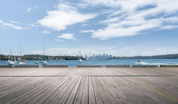 istock empty boardwalk by sydney harbor with many sailboats on sea 976529152