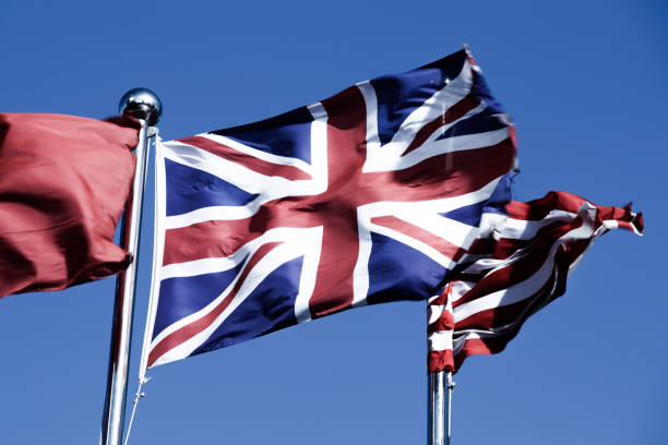 istock Union Jack  &  American Flag  in the Wind 976531652