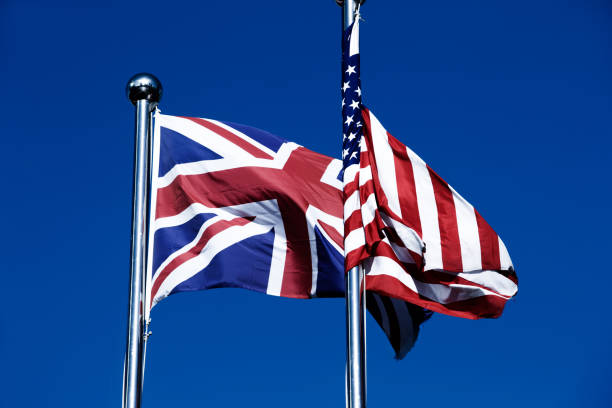 istock Union Jack  &  American Flag  in the Wind 976531932