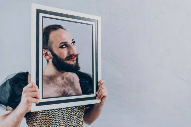istock Man in dress holding a frame 976537212
