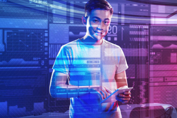 istock Young man looking happy while standing with a new modern device 976539666