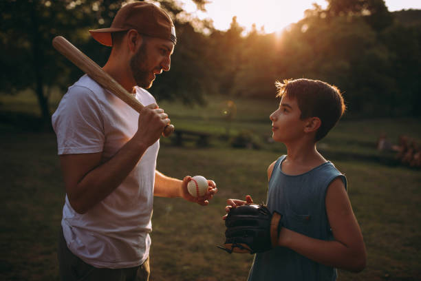 istock Father and his son playing baseball 976539940