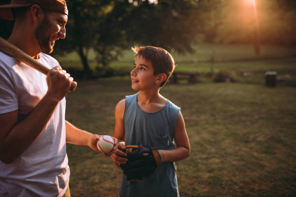 istock Father and his son playing baseball 976539968