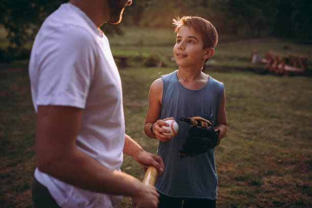 istock Father and his son playing baseball 976540024