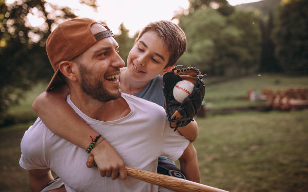 istock Father and his son playing baseball 976542252