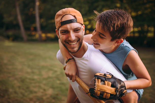 istock Father and his son playing baseball 976542392