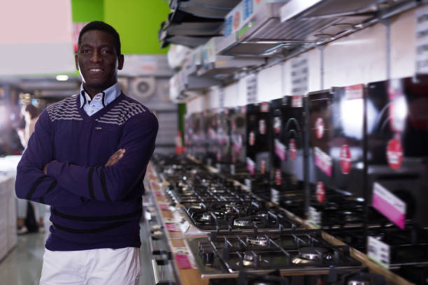 istock Smiling man selecting new cooking top in store 976555122