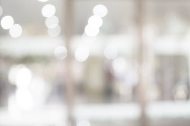 istock white blurred of department store background. Defocused blur background. 976555184