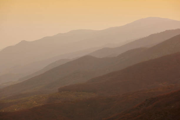 istock Mountains silhouette at dusk. Jerte valley in warm tone 976555432