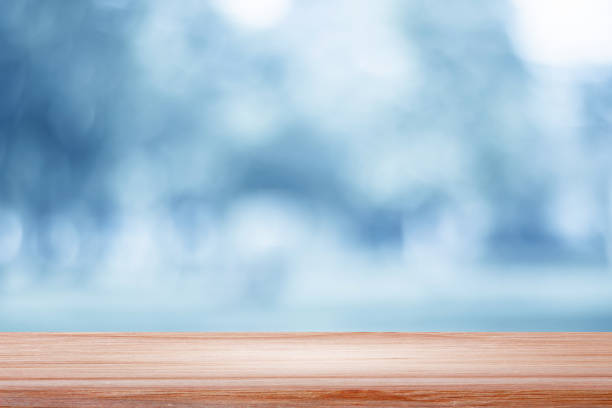 istock empty wooden on blue lighting backdrop. Christmas light background 976557506