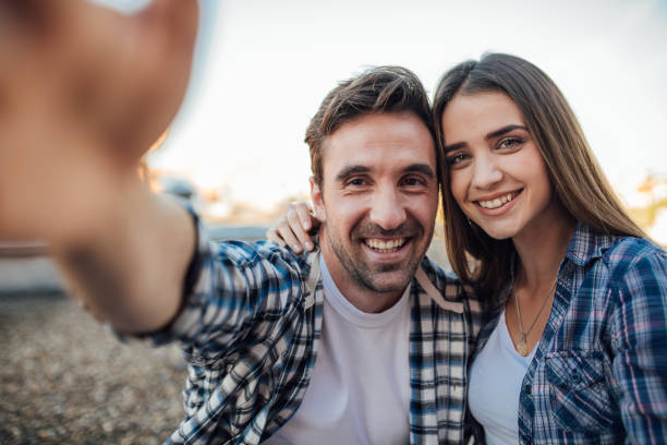 istock Happy young couple taking a selfie on the roof 976563116