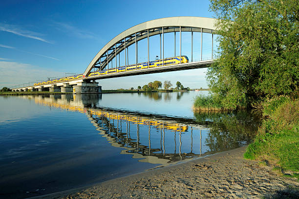 Railway bridge with train  lek river in the netherlands stock pictures, royalty-free photos & images