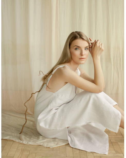 istock Young woman sitting on the floor in studio 976569740