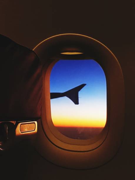 istock sunset and aircraft wing from window seat inside cabin 976572556