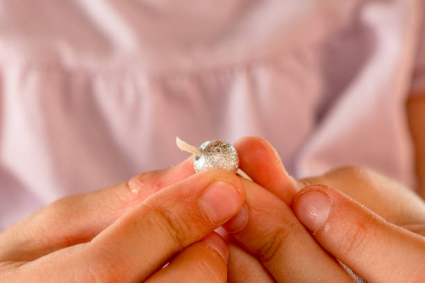 istock Close Up Girl Hands  Working On Beads At Table 976573156